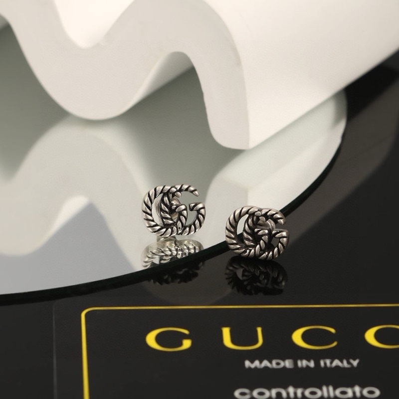 G*u*i earrings